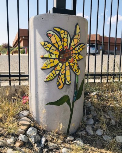 ALMA painted and tiled sunflower at LADE charter school light pole