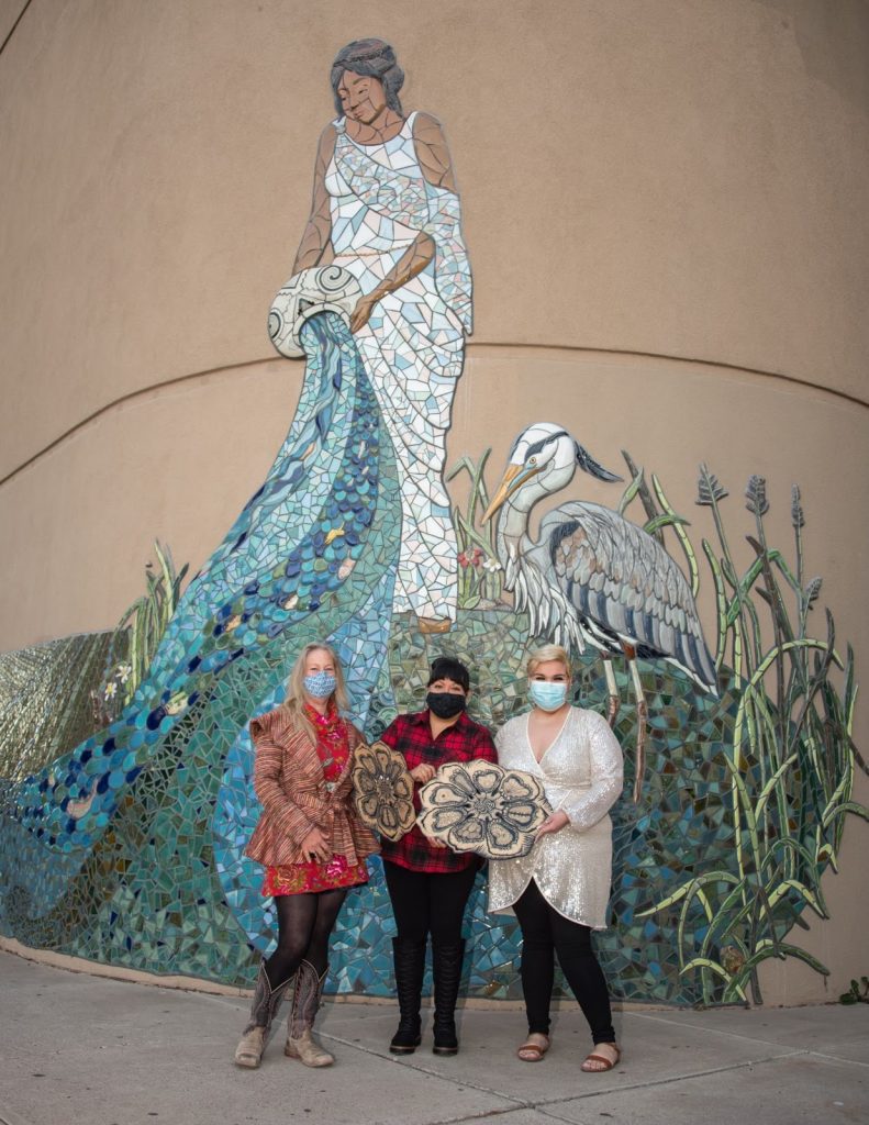 Vanessa Alvarado, Margarita Paz-Pedro, and Cassandra Reid holding the Creative Bravos Legacy Award. 